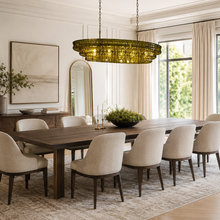 54" Ghiaccio Oval Textured Glass Chandelier with Green Glass and Brass Finish in a Dining Room