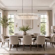 64" Ghiaccio Oval Textured Glass Chandelier with Clear Glass and Bronze Finish in a Dining Room