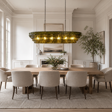 64" Ghiaccio Oval Textured Glass Chandelier with Green Glass and Bronze Finish in a Dining Room