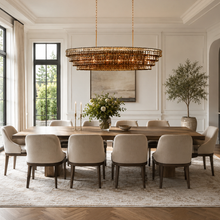 64" Ghiaccio Oval Textured Glass Chandelier with Smoke Glass and Brass Finish in a Dining Room