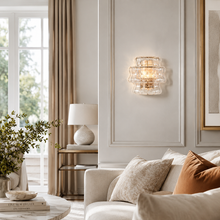 Ghiaccio Textured Glass Wall Light with Clear Glass and Brass Finish in a Living Room
