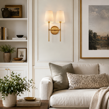 13" Rhodes Fabric Wall Light with Brass Finish in a Living Room
