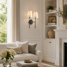 13" Rhodes Fabric Wall Light with Bronze Finish in a Living Room