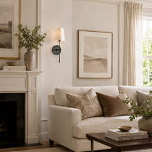 5.5" Rhodes Fabric Wall Light with Bronze Finish in a Living Room